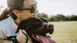 A girl hugging her dog